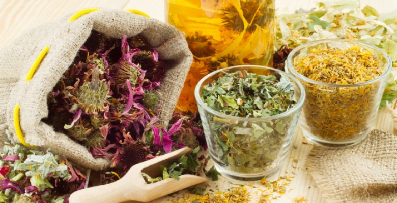 healing herbs and healthy tea on wooden table, herbal medicine