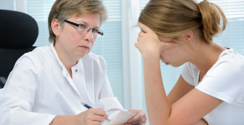 teenage girl suffering with depression in a conversation with a therapist