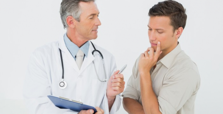 Male doctor in conversation with patient in the medical office