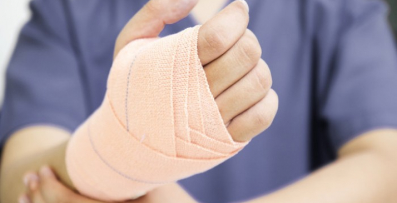 Close up of a hand with medical bandage.