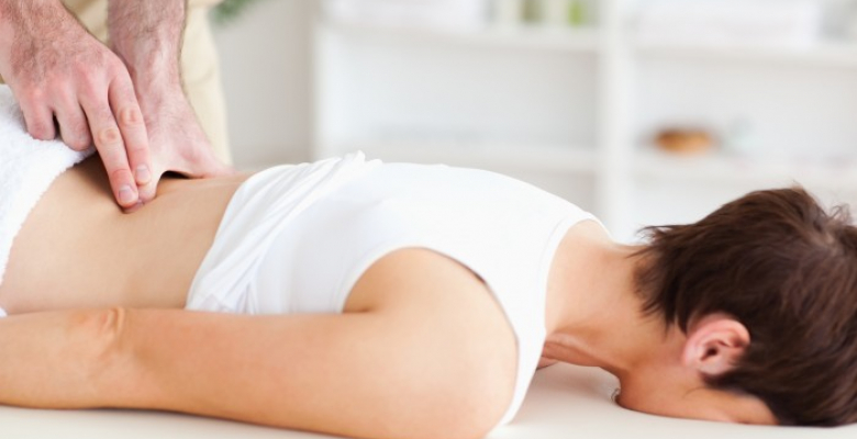 A chiropractor is massaging a woman