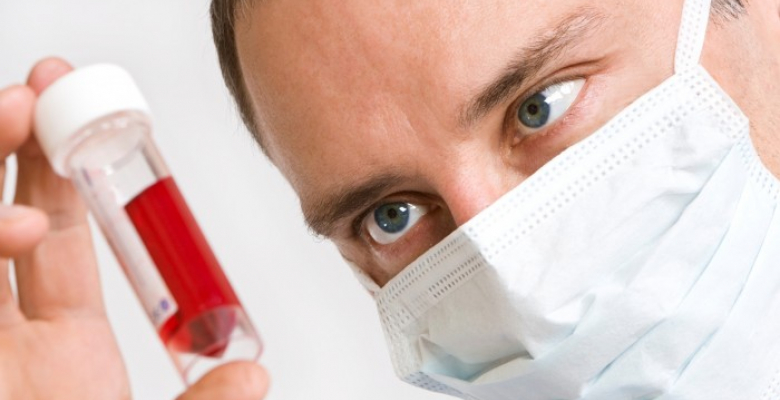 Close up of a male doctor looking at a blood sample