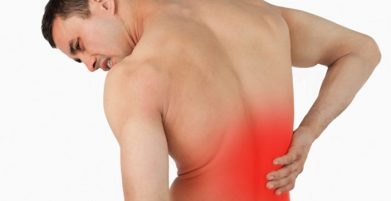 Back view of male suffering from back pain against a white background