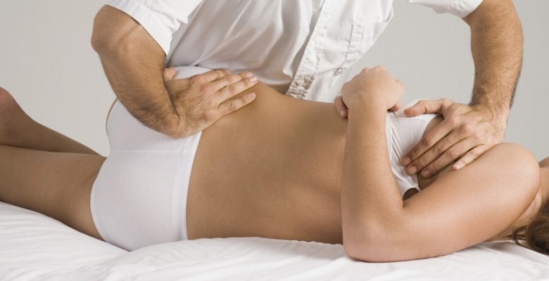 Chiropractor adjusting woman's back